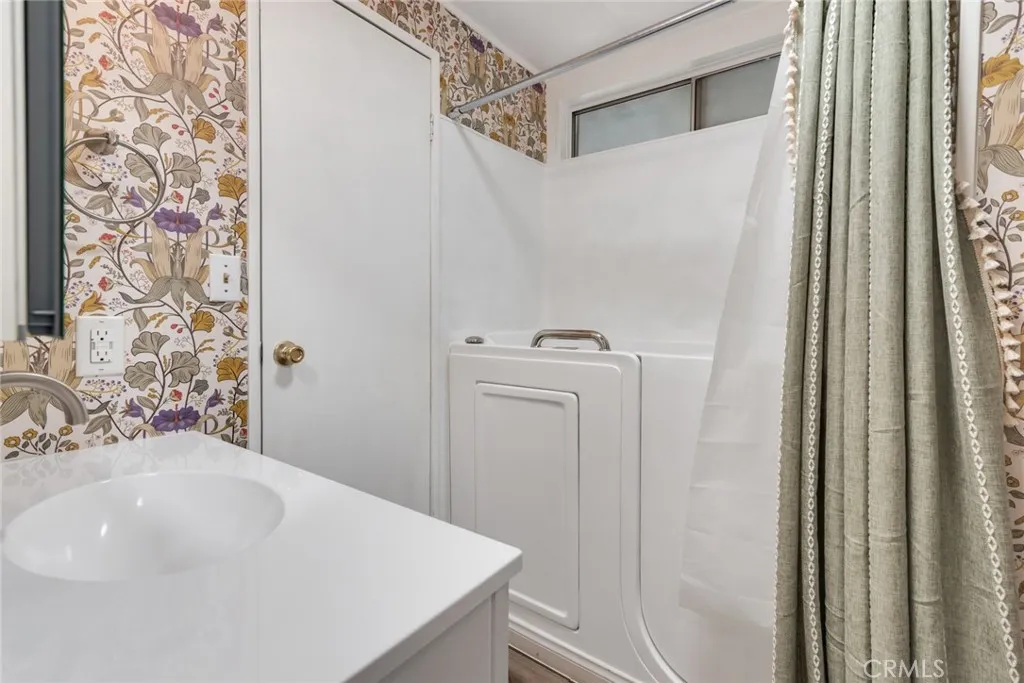 4000 Pierce Street, Unit 295 Riverside, CA 92501 - Photo 14 of 29 a bathroom with a sink a toilet and shower