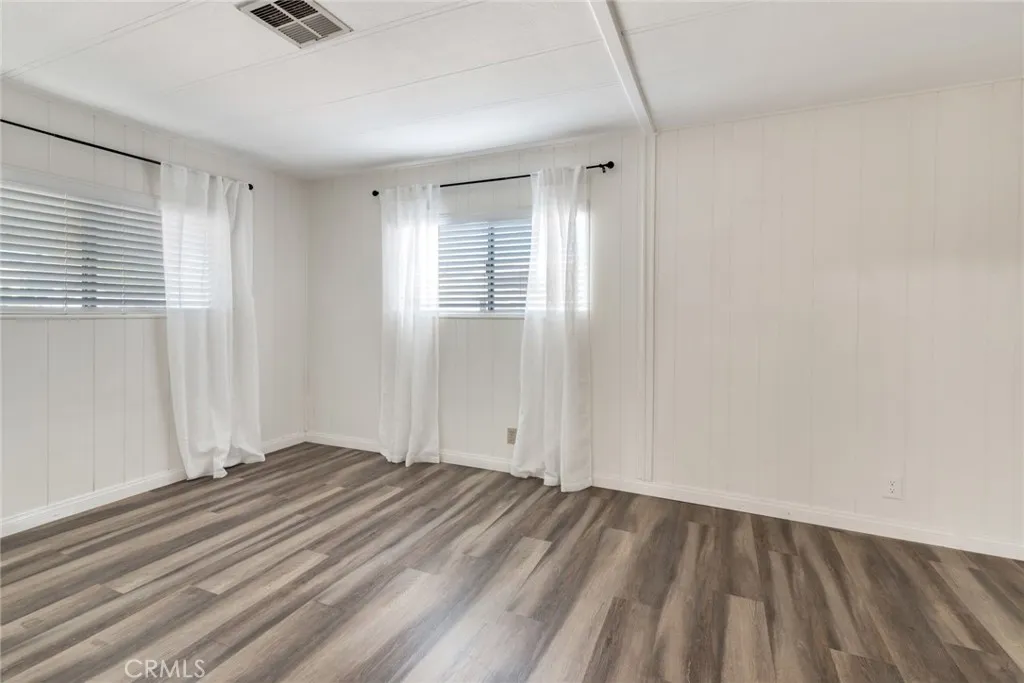 4000 Pierce Street, Unit 295 Riverside, CA 92501 - Photo 15 of 29 a view of an empty room with wooden floor and a window