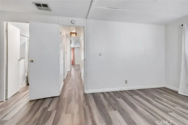 a view of a room with wooden floor