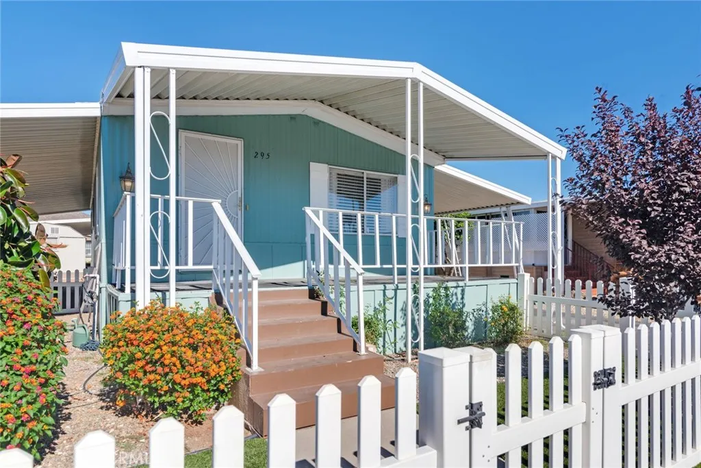 4000 Pierce Street, Unit 295 Riverside, CA 92501 - Photo 2 of 29 a front view of a house with a garden