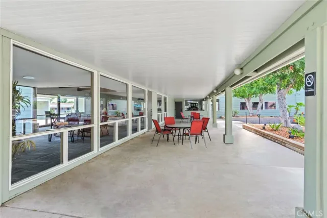 a view of a dining room with furniture and garden view