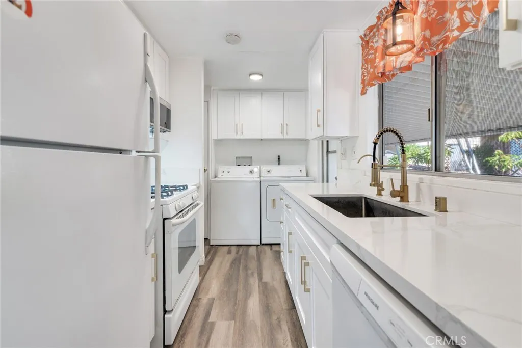 4000 Pierce Street, Unit 295 Riverside, CA 92501 - Photo 8 of 29 a kitchen with a sink a stove and cabinets