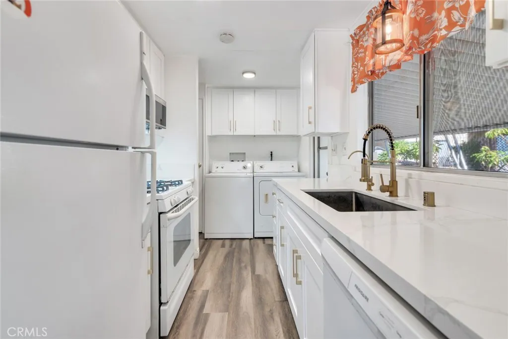 4000 Pierce Street, Unit 295 Riverside, CA 92501 - Photo 8 of 29 a kitchen with a sink a stove and cabinets