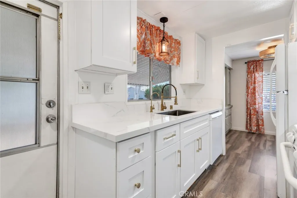 4000 Pierce Street, Unit 295 Riverside, CA 92501 - Photo 9 of 29 a kitchen with white cabinets and sink