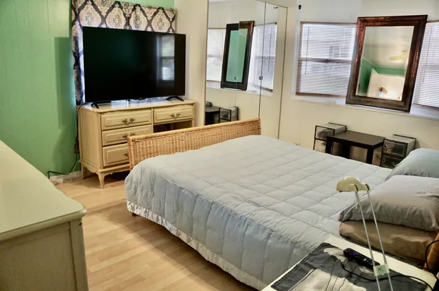 a bedroom with a bed and a flat screen tv