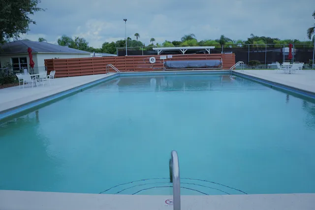 a backyard view with a seating space and fir pit