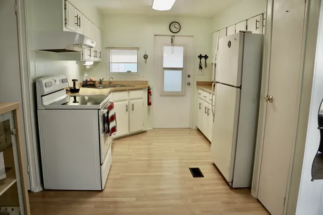 a kitchen with a stove a refrigerator and a stove