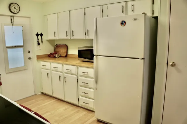 a white refrigerator freezer sitting in a kitchen