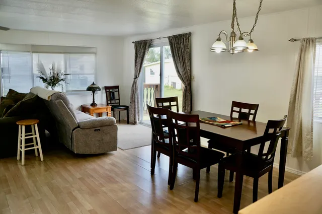a view of a dining room with furniture window and wooden floor