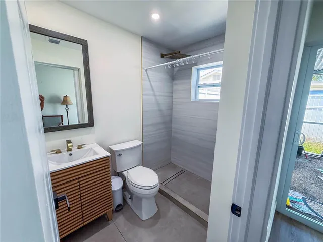 a bathroom with a toilet sink and shower