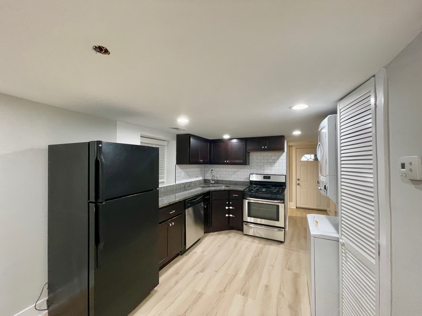 2239 West 19th Street, Unit G Chicago, IL 60608 - Photo 7 of 17 a kitchen with stainless steel appliances granite countertop a refrigerator a sink and a stove