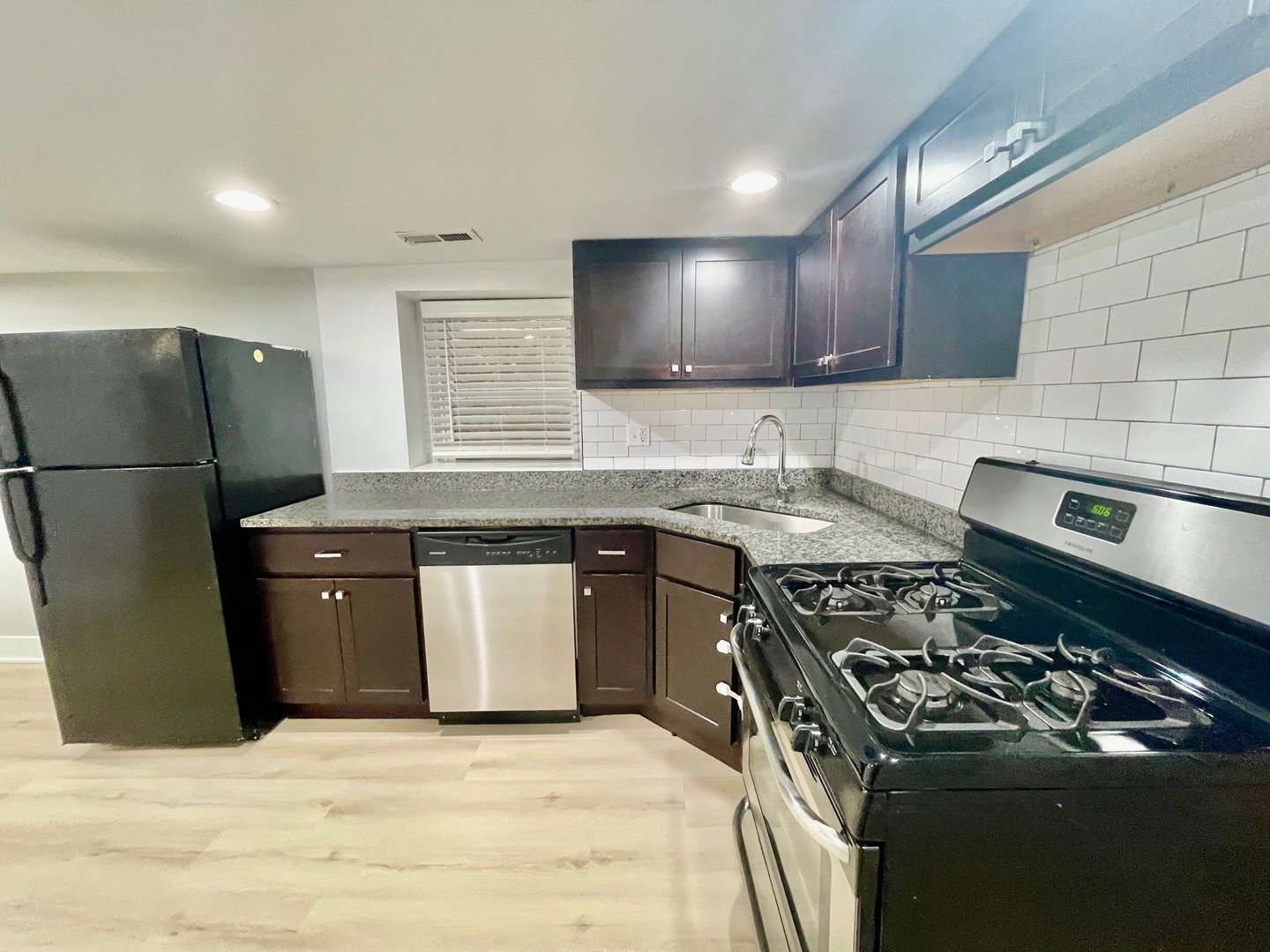 2239 West 19th Street, Unit G Chicago, IL 60608 - Photo 9 of 17 a kitchen with a stove a sink and a refrigerator