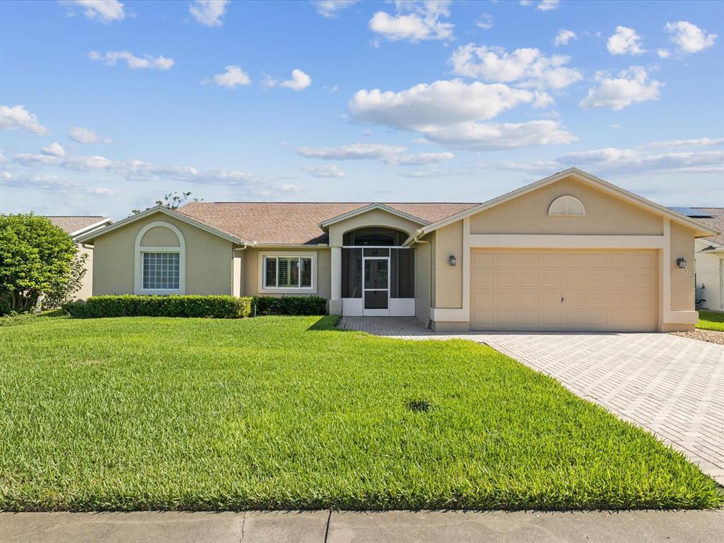 8401 Pavilion Drive Hudson, FL 34667 - Photo 1 of 81 a front view of a house with a yard and garage