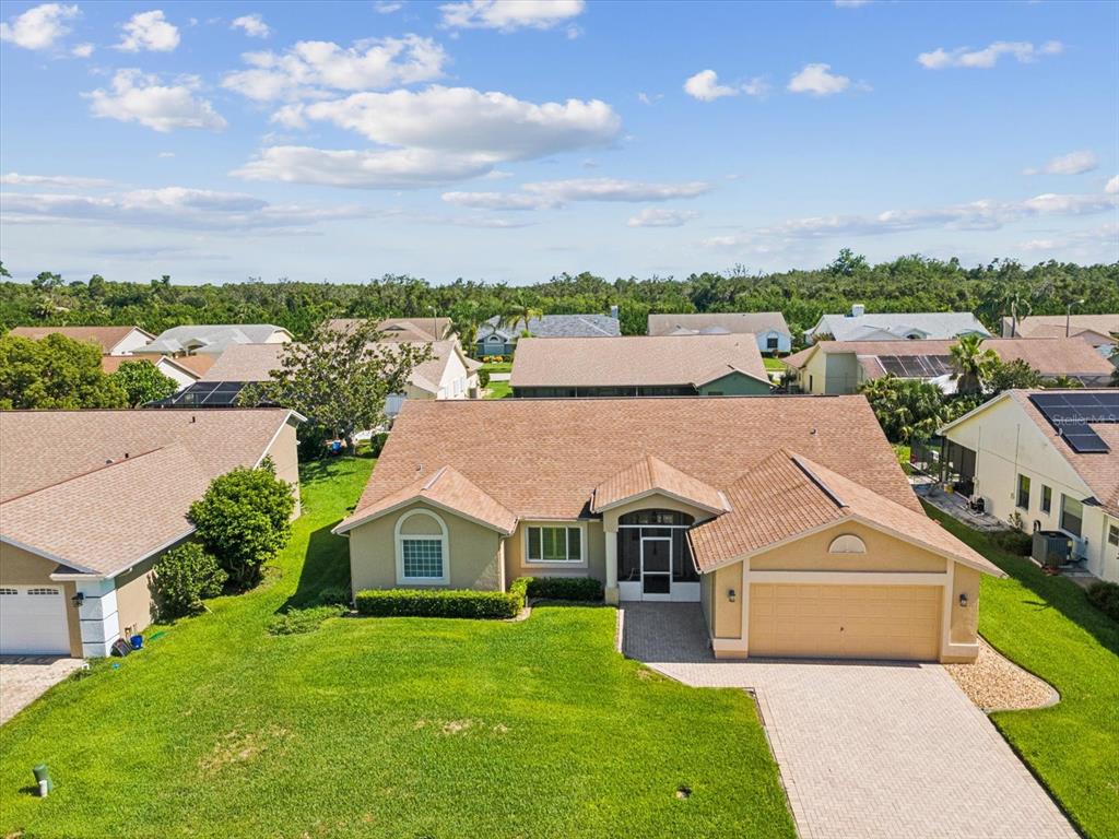 8401 Pavilion Drive Hudson, FL 34667 - Photo 2 of 81 an aerial view of a house with a big yard and large trees