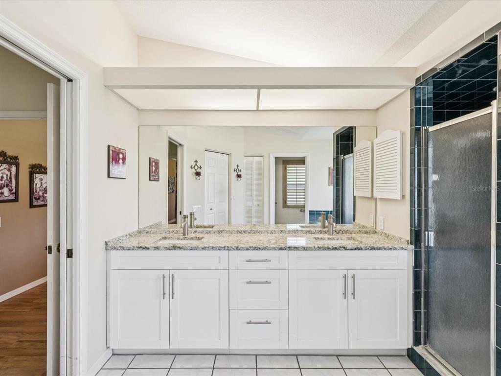 8401 Pavilion Drive Hudson, FL 34667 - Photo 25 of 81 a bathroom with a granite countertop sink and a mirror