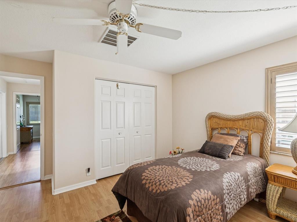 8401 Pavilion Drive Hudson, FL 34667 - Photo 27 of 81 a bedroom with a bed and wooden floor