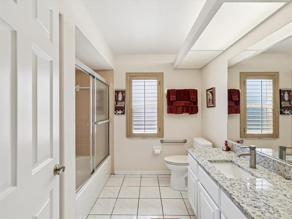 8401 Pavilion Drive Hudson, FL 34667 - Photo 28 of 81 a bathroom with a granite countertop sink mirror vanity and toilet