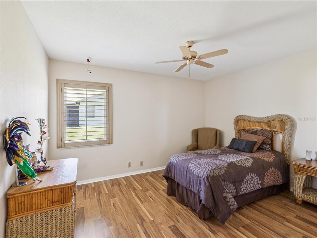 8401 Pavilion Drive Hudson, FL 34667 - Photo 30 of 81 a bedroom with a bed and wooden floor