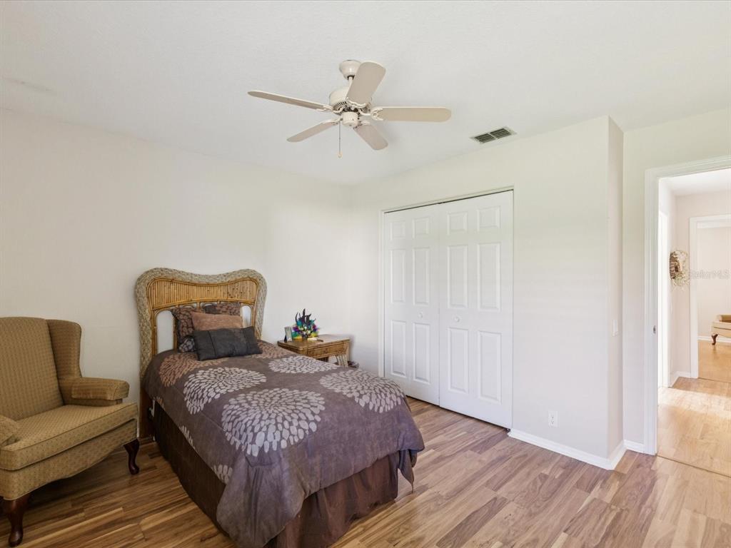 8401 Pavilion Drive Hudson, FL 34667 - Photo 31 of 81 a bedroom with a bed and wooden floor