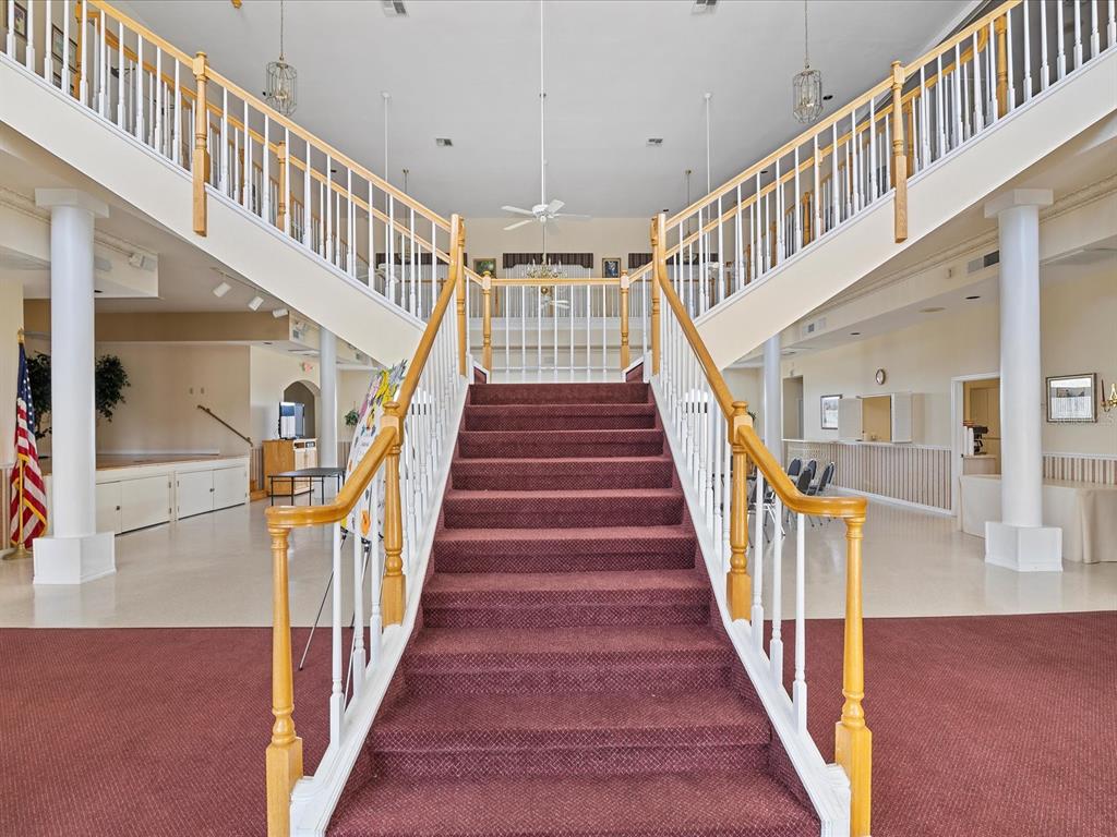 8401 Pavilion Drive Hudson, FL 34667 - Photo 56 of 81 a view of staircase with lots of frames on wall and wooden floor