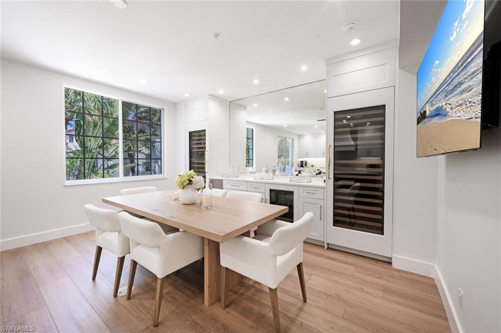 888 10th Street South, Unit 101 Naples, FL 34102 - Photo 17 of 44 a view of a dining room with furniture and wooden floor