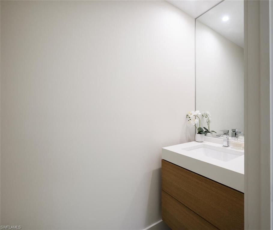 888 10th Street South, Unit 101 Naples, FL 34102 - Photo 20 of 44 a bathroom with a sink and a mirror