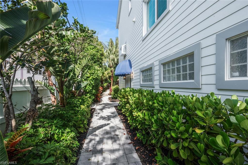 888 10th Street South, Unit 101 Naples, FL 34102 - Photo 2 of 44 a view of a pathway of the house front of a house