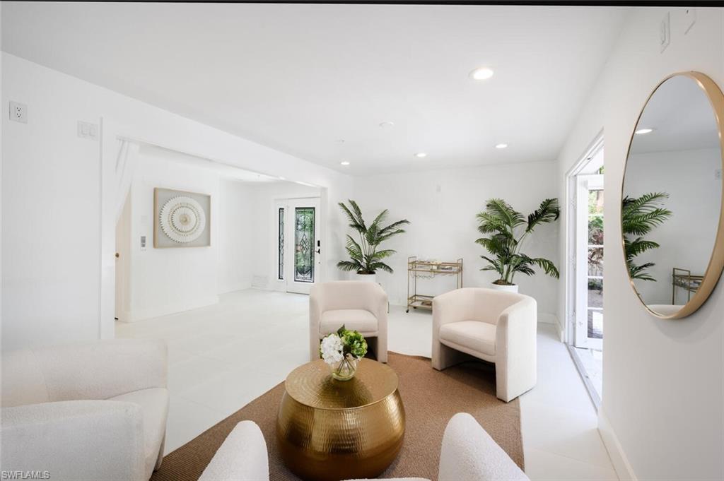 888 10th Street South, Unit 101 Naples, FL 34102 - Photo 21 of 44 a living room with furniture and a potted plant