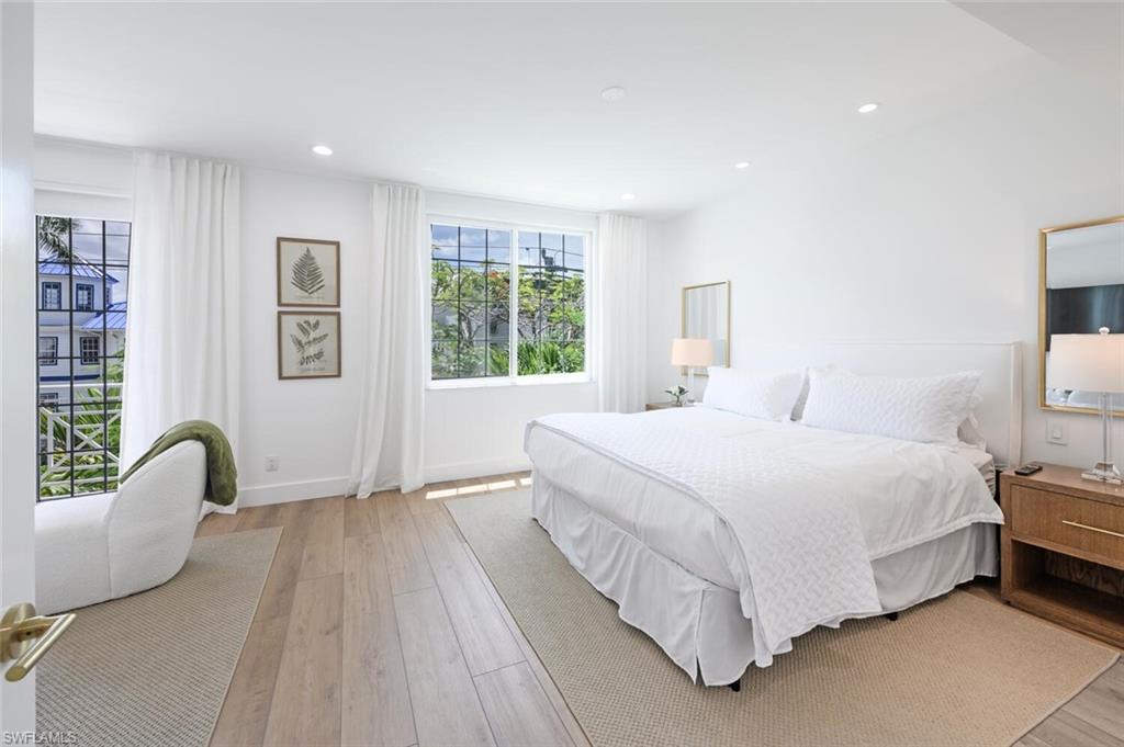 888 10th Street South, Unit 101 Naples, FL 34102 - Photo 23 of 44 a bedroom with bed and a window