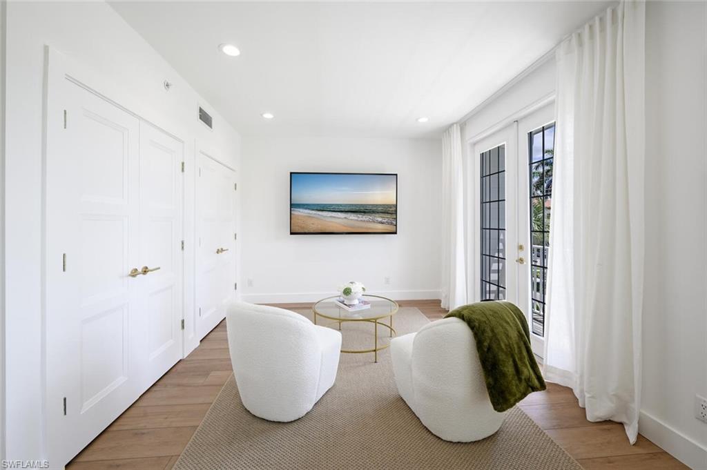 888 10th Street South, Unit 101 Naples, FL 34102 - Photo 24 of 44 a living room with furniture and a large window