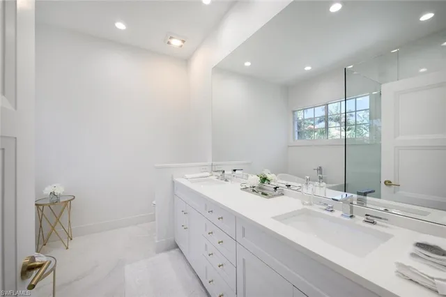 a white bath tub sitting next to a toilet