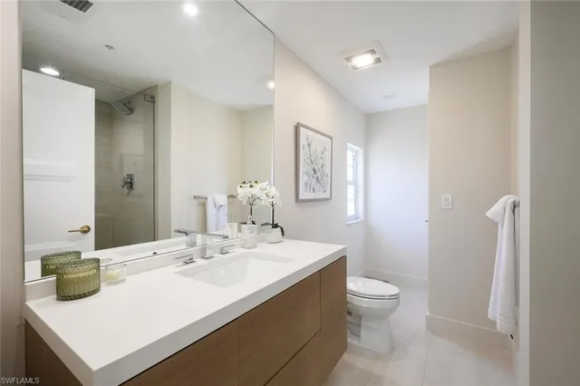a bathroom with a sink a mirror and shower