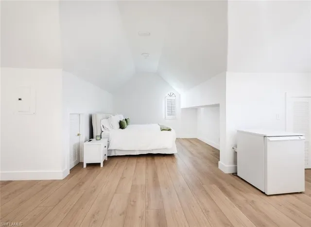 a view of a room with wooden floor and window
