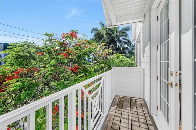 a view of balcony with wooden floor and fence