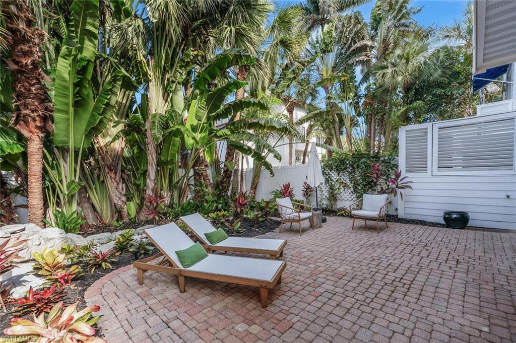 888 10th Street South, Unit 101 Naples, FL 34102 - Photo 42 of 44 a view of a bench in a backyard
