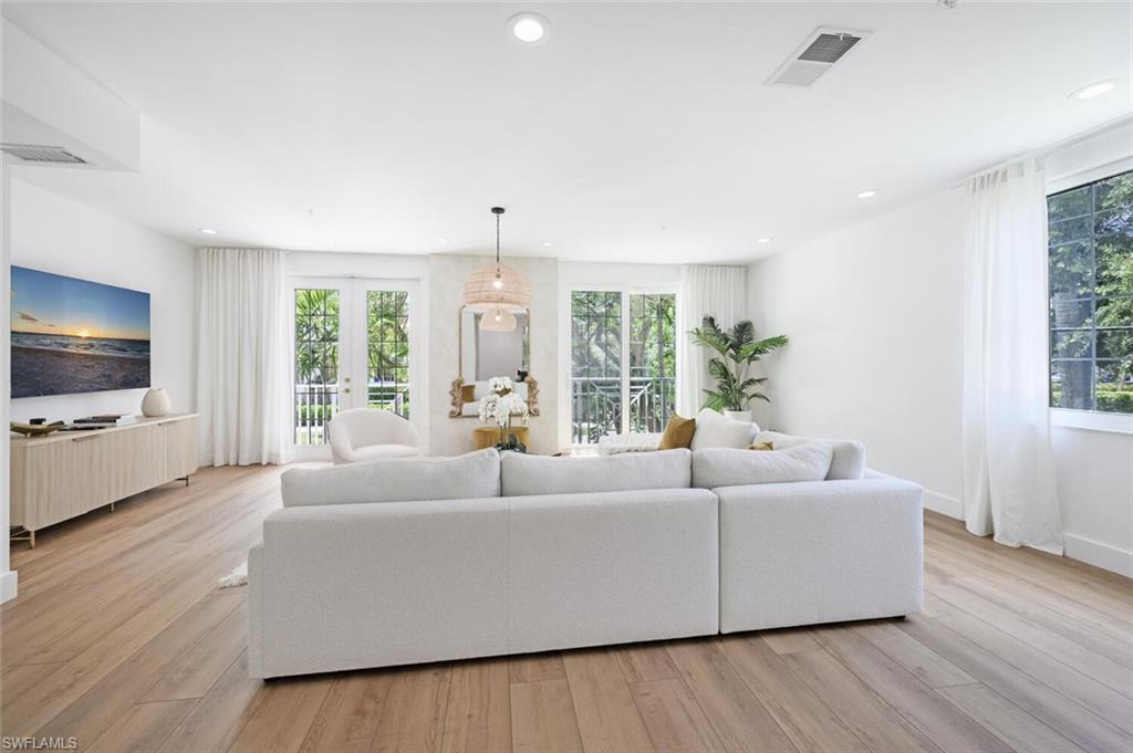 888 10th Street South, Unit 101 Naples, FL 34102 - Photo 7 of 44 a living room with furniture and a flat screen tv