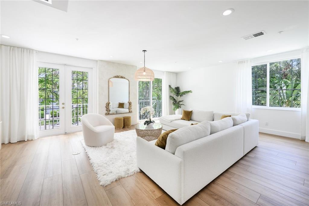 888 10th Street South, Unit 101 Naples, FL 34102 - Photo 9 of 44 a living room with furniture and a large window