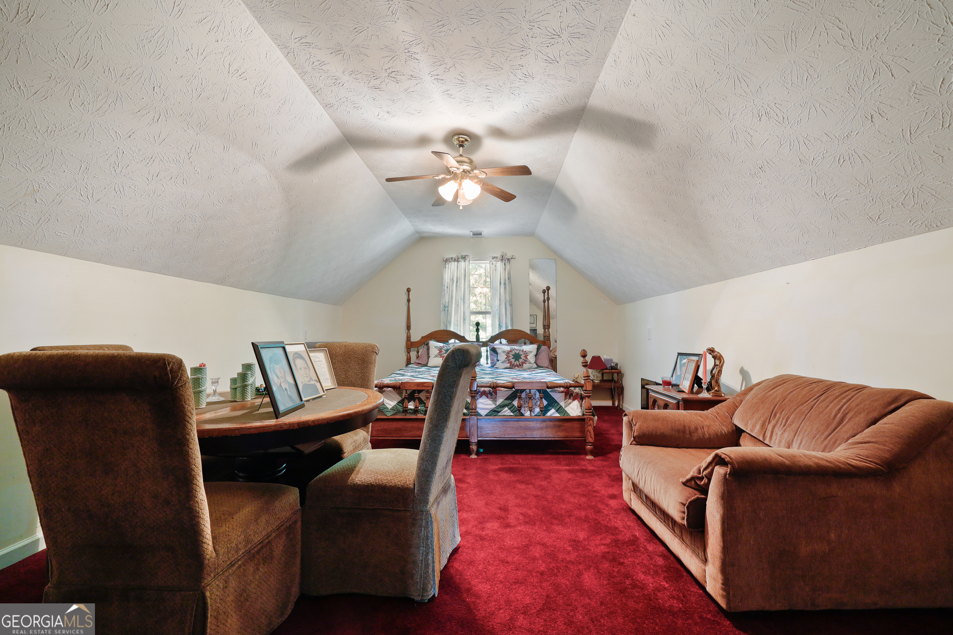 2433 Bear Creek Road Statham, GA 30666 - Photo 31 of 58 a living room with furniture a chandelier and a rug