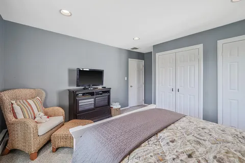 a bedroom with furniture and a flat screen tv