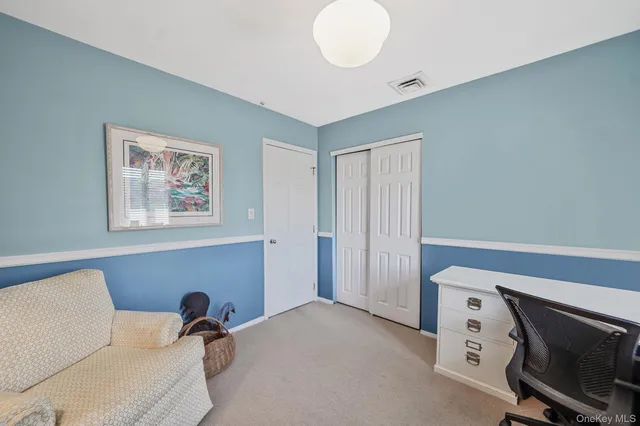 a view of a livingroom with a couch and a fan