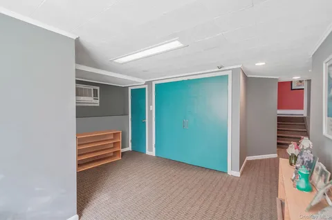 a view of room with stairs and wooden floor