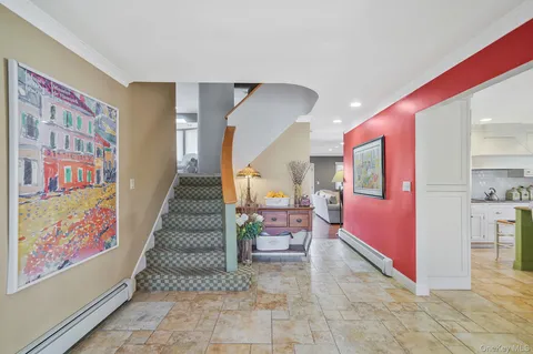 a living room with furniture and stairs