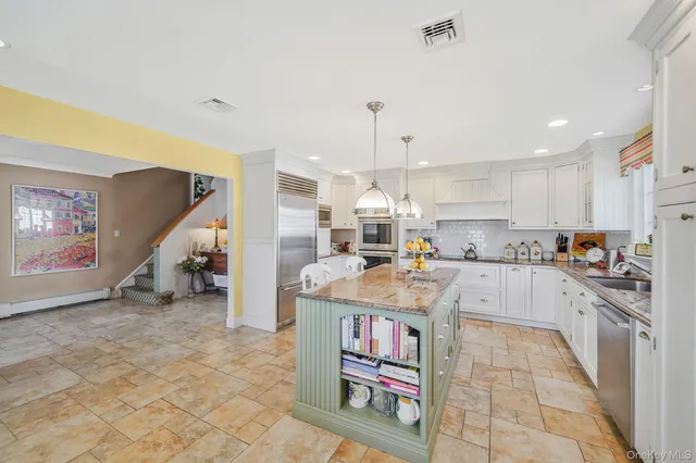 a kitchen with stainless steel appliances granite countertop a sink and a refrigerator
