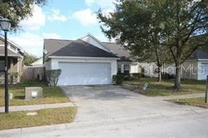 a front view of a house with a yard garage and outdoor seating