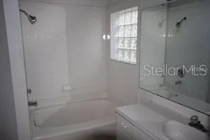 a bath tub sitting next to a window