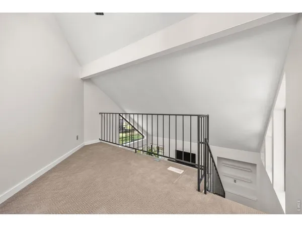 a view of a hallway with a ceiling fan