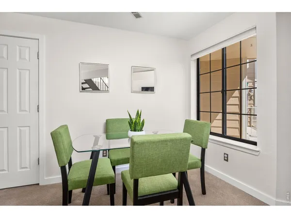 a view of a dining room with furniture and a window
