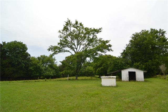 1820 Fellowship Road Mount Juliet, TN 37122 - Photo 9 of 11 Backyard shows the well house and more storage buildings