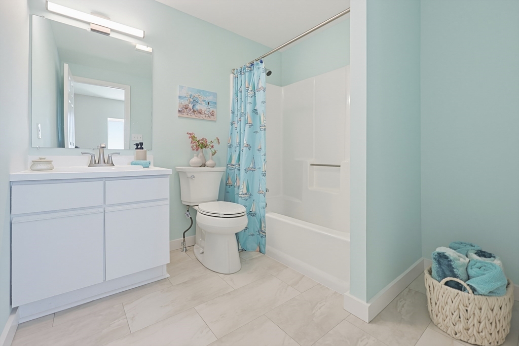 45 Main Street, Unit 35 Wareham, MA 02571 - Photo 21 of 34 a spacious bathroom with a toilet sink and mirror