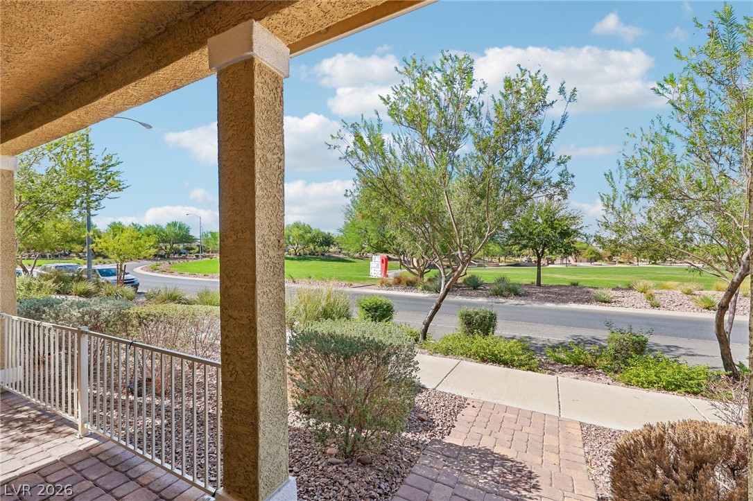 1100 East Sunset Road Henderson, NV 89011 - Photo 8 of 63 A covered front porch looks out over neighborhood green space and a paved street.